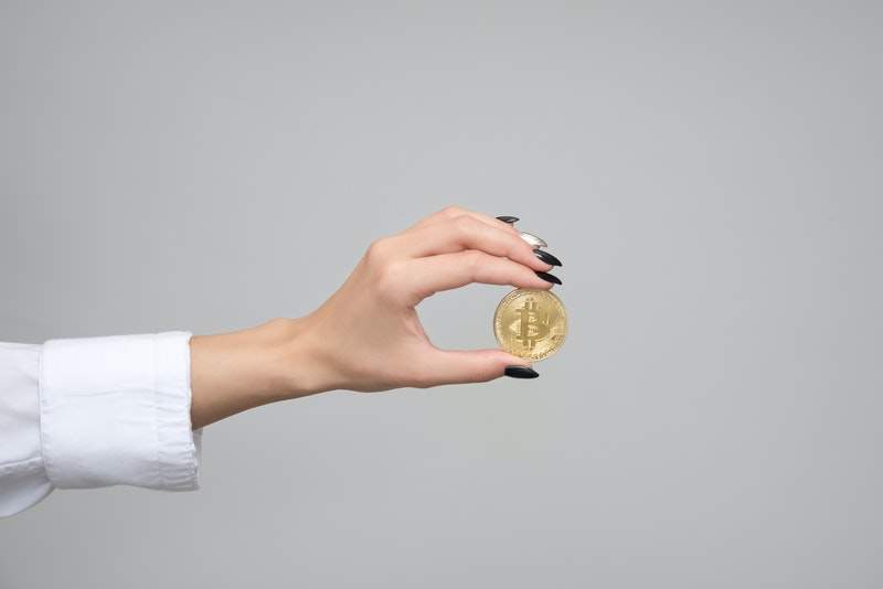 woman holding bitcoin
