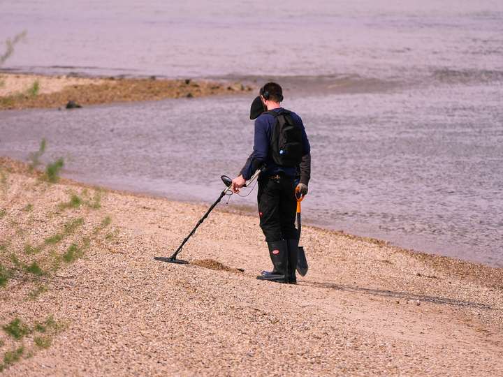 searching with metal detector on the beach