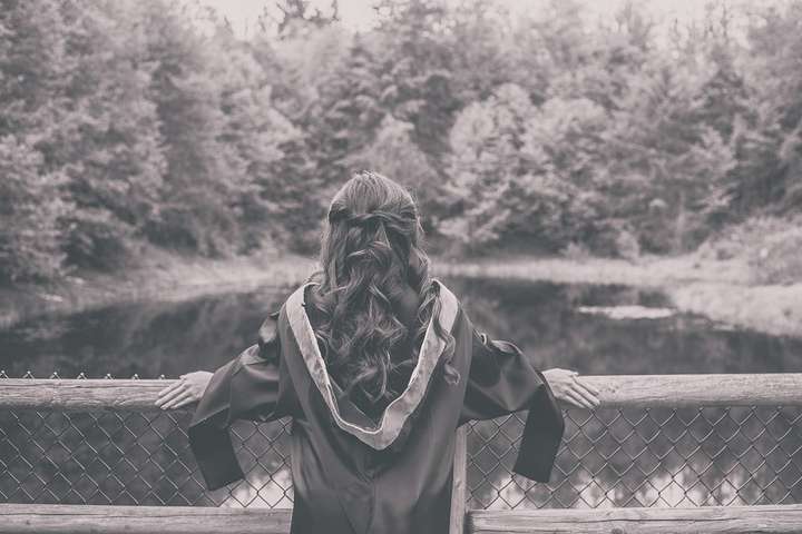 female student watching pond